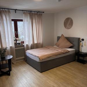 a bedroom with a bed and a window at Waldblick Glatt in Sulz am Neckar