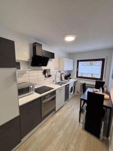 a kitchen with white appliances and a table in it at Waldblick Glatt in Sulz am Neckar