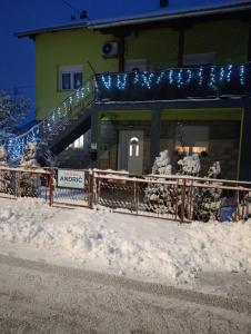 een gebouw met een hek in de sneeuw bij Andrić in Gračac
