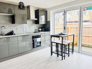 a kitchen with stainless steel appliances and a counter at TANZANITE - Ground Floor 2BR apart, Pet friendly in Cambridge +29 photos
