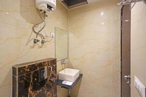 a bathroom with a toilet and a sink and a shower at Comfy Stay Hotels 2nd Floor in New Delhi +19 photos
