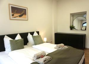 Postel nebo postele na pokoji v ubytování GreenTreeHomes - Stadtvilla Linde