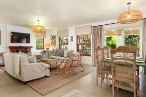 a living room with a couch and chairs at Noordhoek Village Hotel in Noordhoek