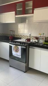 a kitchen with a stove and a sink in it at Casa temporada em Perocão in Guarapari +15 photos