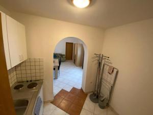 a kitchen with a sink and an archway in a room at Apartments Matteo in Omišalj +64 photos