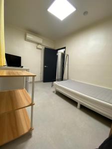 an empty room with a bed and a window at 더스테이365 디럭스 in Seoul
