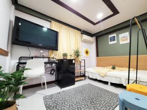 a room with two beds and a flat screen tv at 더스테이365 디럭스 in Seoul