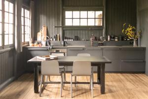 a kitchen with a table and chairs in a room at Neska Lodge in Saint-Rémy-lʼHonoré