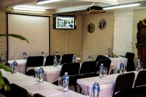 a room with tables and chairs with water bottles on them at Matts Rest Bnb & Self-catering in Pietermaritzburg +47 photos