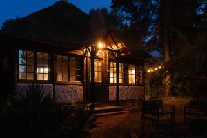 a house lit up at night with lights at Neska Lodge in Saint-Rémy-lʼHonoré