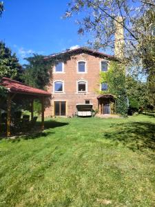 a large brick house with a large yard at Villa Oranje in Bolków