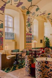 a lobby with tables and chairs in a building at Wilde Vienna Fleischmarkt in Vienna