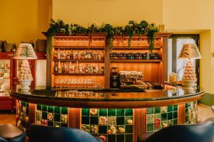 a bar in a restaurant with green tiles at Wilde Vienna Fleischmarkt in Vienna