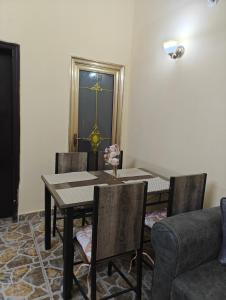 a dining room with a table and chairs at TATAICHA Appart in NʼDjamena +9 photos