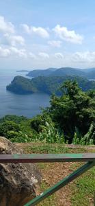 a view of a large body of water from a hill at Maria's Cosy Haven in Barataria