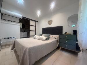 a bedroom with a bed with a blue dresser and a tub at Auberge aux 1000 saveurs in Malay-le-Petit