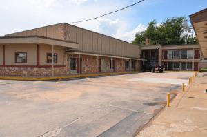 an empty parking lot in front of a building at Regency Inn in Chickasha