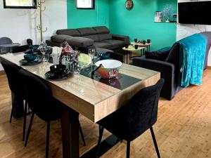 a living room with a table with chairs and a couch at Panorama in Seigy +15 photos
