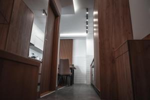 a hallway with a table and a chair in a room at Green Peak in Divčibare
