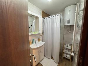 a small bathroom with a sink and a shower at Green Peak in Divčibare +47 photos