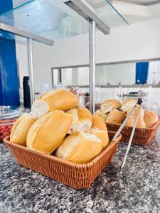 two baskets of bread sitting on top of a counter at Hotel Dairy Walley in Itapetinga +11 photos