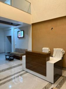 a living room with a tv on a wall at ENERGY Inn in Kotri Kalān