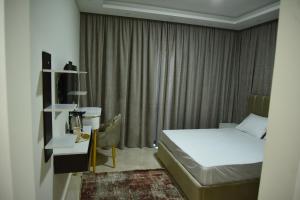 a hotel room with a bed and a window at White House Boutique Sharm in Banī Ghālib