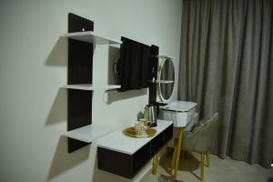 a room with a tv and a desk with a mirror at White House Boutique Sharm in Banī Ghālib