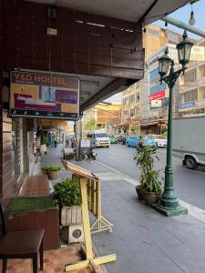 a building with a sign on a city street at Y&D Hostel in Bangkok