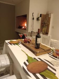 a bottle of wine sitting on a table with wine glasses at Entre Jazmines & Glicinas in Lobos +6 photos