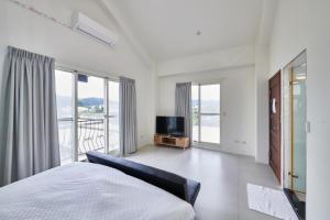 a bedroom with a bed and a flat screen tv at 旅居Villa in Dongshan +61 photos
