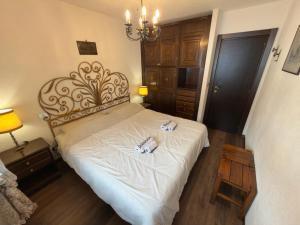 a bedroom with a bed with two candles on it at Neve 5 Apartment - Clotes Slope Access in Sauze d'Oulx