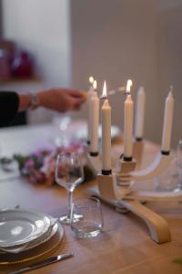 a candle holder on a table with plates and glasses at Gite Le Rebanchon in Le Monêtier-les-Bains +26 photos