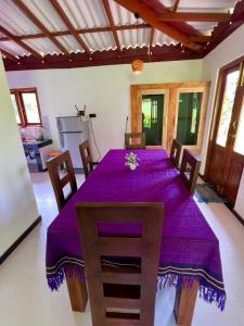 a dining room with a purple table and chairs at King CoCo House in Dickwella
