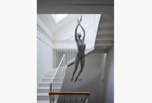 a painting of a woman jumping down a staircase at donebe boutique hotel & private wellness in Kutná Hora