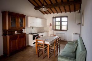 a kitchen and dining room with a table and chairs at AGRITURISMO La COLLINA del SOLE in Coltavolino