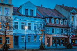 a group of buildings on a street at night at Exklusives und stilvoll eingerichtetes Apartment für Erwachsene in Bad Liebenwerda