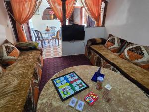 a living room with two couches and a table at tigmi oufla in Taghazout
