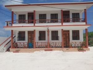 a house on the beach with a balcony at Karibu House Bwejuu in Bwejuu +6 photos
