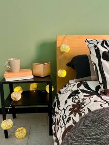 a bedroom with a bed and a night stand with a table with a bed gmaxwell at Fuori Arena in Casalecchio di Reno +9 photos