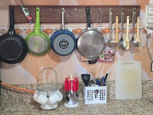 a kitchen counter with pots and pans and utensils at tigmi oufla in Taghazout +9 photos