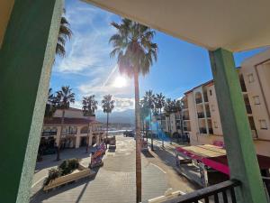 a view of a street with palm trees and buildings at T2 cosy et rénové avec vue sur le port d'Argelès pour 4 personnes in Argelès-sur-Mer