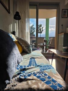 a bedroom with a bed with a view of a balcony at T2 cosy et rénové avec vue sur le port d'Argelès pour 4 personnes in Argelès-sur-Mer +49 photos
