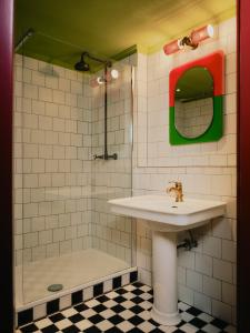 a bathroom with a sink and a shower at The Dean Berlin in Berlin +45 photos