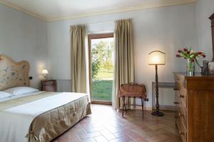 a bedroom with a bed and a large window at Valle di Assisi Country Apartments in Assisi