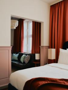 a hotel room with a bed and a couch at The Dean Berlin in Berlin