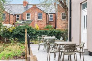 a patio with tables and chairs in front of a building at Nottingham Forest The City Ground Studio Apartments in Nottingham