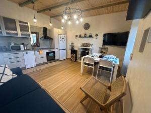 a living room and kitchen with a table and chairs at Ana & Angelo House Vuno Himare in Vuno