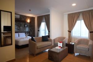 a hotel room with a bed and a living room at Ream Hotel Amman in Amman