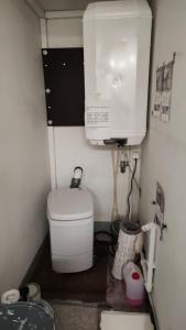 a small bathroom with a toilet and a sink at Lemmenjoen Lumo - Nature Experience & Accommodation in Lemmenjoki +130 photos